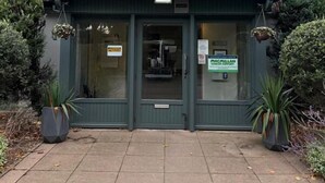 A hotel named "Raceby" with a green facade, a signboard above the entrance, and a small garden area with potted plants. - The Raceby Hotel, Doncaster (South Yorkshire), Part of the AG Collection (Doncaster)
