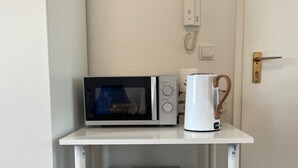 A compact kitchenette with a microwave, coffee maker, and mini-fridge. - Superior Apartment: City location Museums Castles Phantasialand shuttle on the doorstep (Brühl)