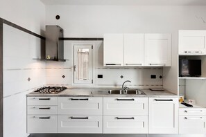 Fridge, stovetop, electric kettle, cookware/dishes/utensils