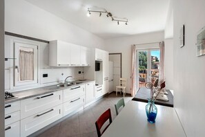 Fridge, stovetop, electric kettle, cookware/dishes/utensils