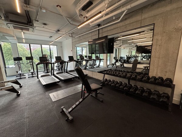 A gym with treadmills, weight benches, and dumbbells. - *NEW Mid-Century Modern 2B/1B (Halifax)
