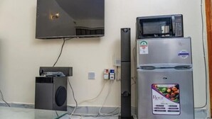 Una kitchenette con un refrigerador Bosch, un microondas y un horno empotrado.