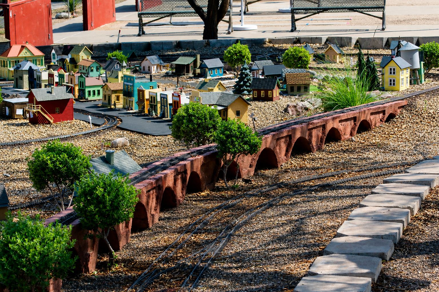A model train layout with miniature buildings and a bridge.