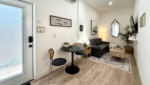 A compact living space with a dining area, a sofa, a mirror, and a small side table. - Private 1 bedroom luxury mother-in-law suite close proximity to Midtown Tampa (Tampa)