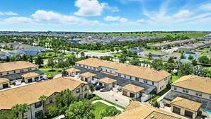 A residential area with multiple houses featuring flat roofs and solar panels. - Perfect Retreat with Incredible Resort! (Kissimmee)