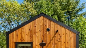 A wooden cabin with a window and a shower. - Vesta Nook! With Shower, Queen Bed & pullout sofa (Sullivan)