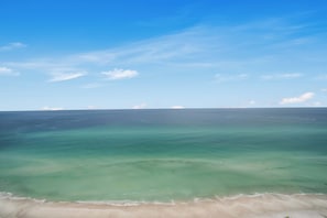 A beach with clear turquoise water and a sandy shore.