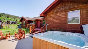 A wooden cabin with a hot tub, outdoor seating, and a view of the surrounding landscape. - < 2 Mi to Granby Ranch: Home w/ Hot Tub & Decks! (Granby)