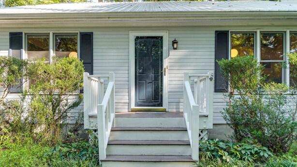 A house with a front porch, a door, and a set of stairs leading to the entrance. - Carrboro Quaint! 2 Mi to Heart of Chapel Hill! (Carrboro)