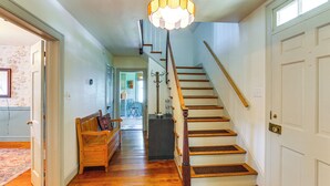 A staircase with wooden steps and a white door at the top. - Walkable Location: Historic Home in Charles Town! (Charles Town)