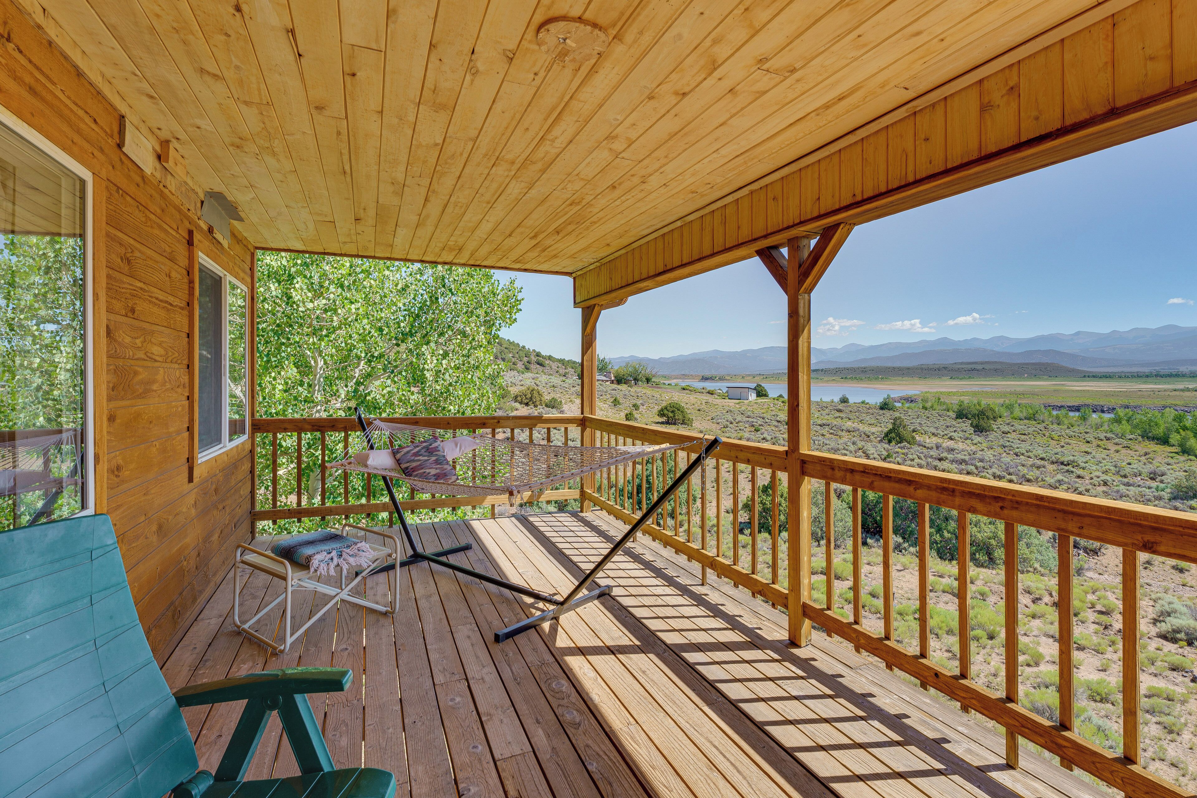 A wooden deck with a view of a mountainous landscape.