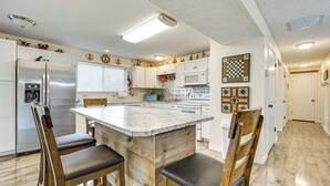 A kitchen with a central island, wooden chairs, a refrigerator, and a microwave. - Hike & Explore: Retreat w/ Scenic Views in Selah! (Selah)