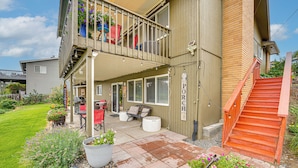 A two-story building with a covered patio area, outdoor seating, and a wooden staircase. - Hike & Explore: Retreat w/ Scenic Views in Selah! (Selah)