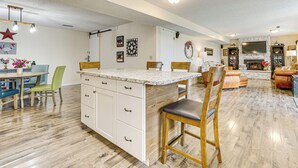 A spacious living area with a kitchen island, wooden flooring, and a fireplace. - Hike & Explore: Retreat w/ Scenic Views in Selah! (Selah)