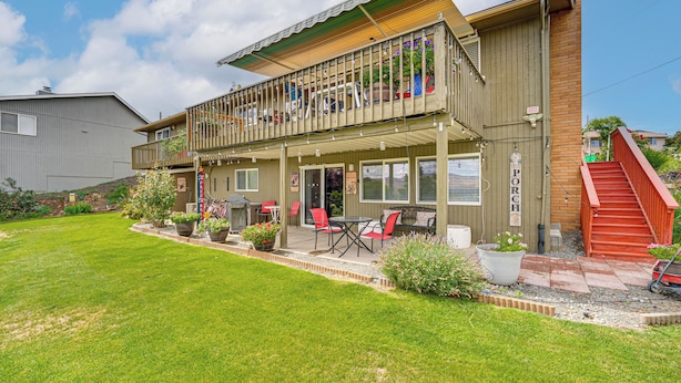 A two-story building with a balcony, outdoor seating area, and a red staircase. - Hike & Explore: Retreat w/ Scenic Views in Selah! (Selah)