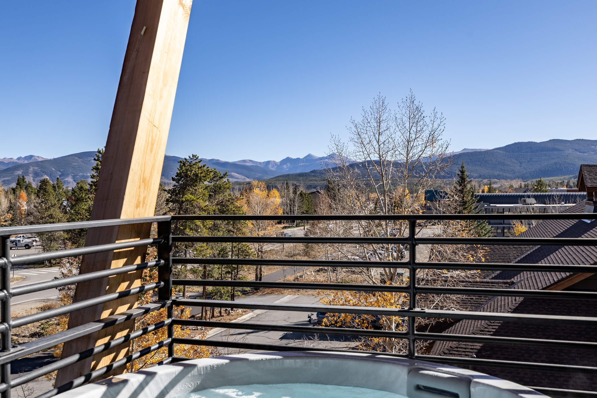 A balcony with a metal railing overlooking a mountainous landscape.