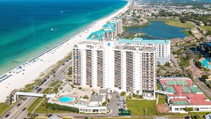 A high-rise hotel with multiple balconies overlooking a beach and a lake. - Surfside 0708a 2 Bedroom Condo (Miramar Beach)