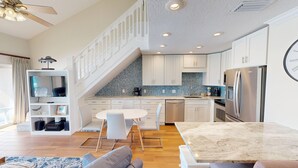 A modern kitchen with white cabinets, a marble countertop, and stainless steel appliances. - Coral Reef Club 36 3 Bedroom Condo (Destin)