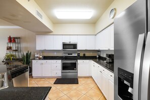 Fridge, microwave, coffee/tea maker, cookware/dishes/utensils