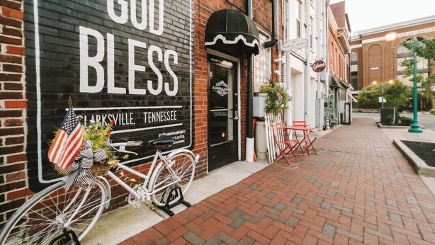 A storefront with a sign reading "God Bless" and "Clarksville, Tennessee". - Loft #210 (540 N 2nd St) (Fredericton)