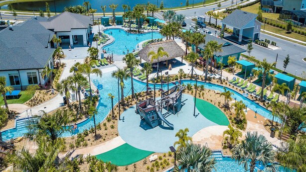 An aerial view of a resort with multiple swimming pools, palm trees, and a lake in the background. - Special Offer! Lake View/Themed BR/Pool/SPA 22093 (Kissimmee)