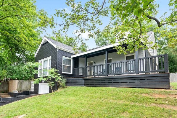 A two-story house with a covered porch and a garage.