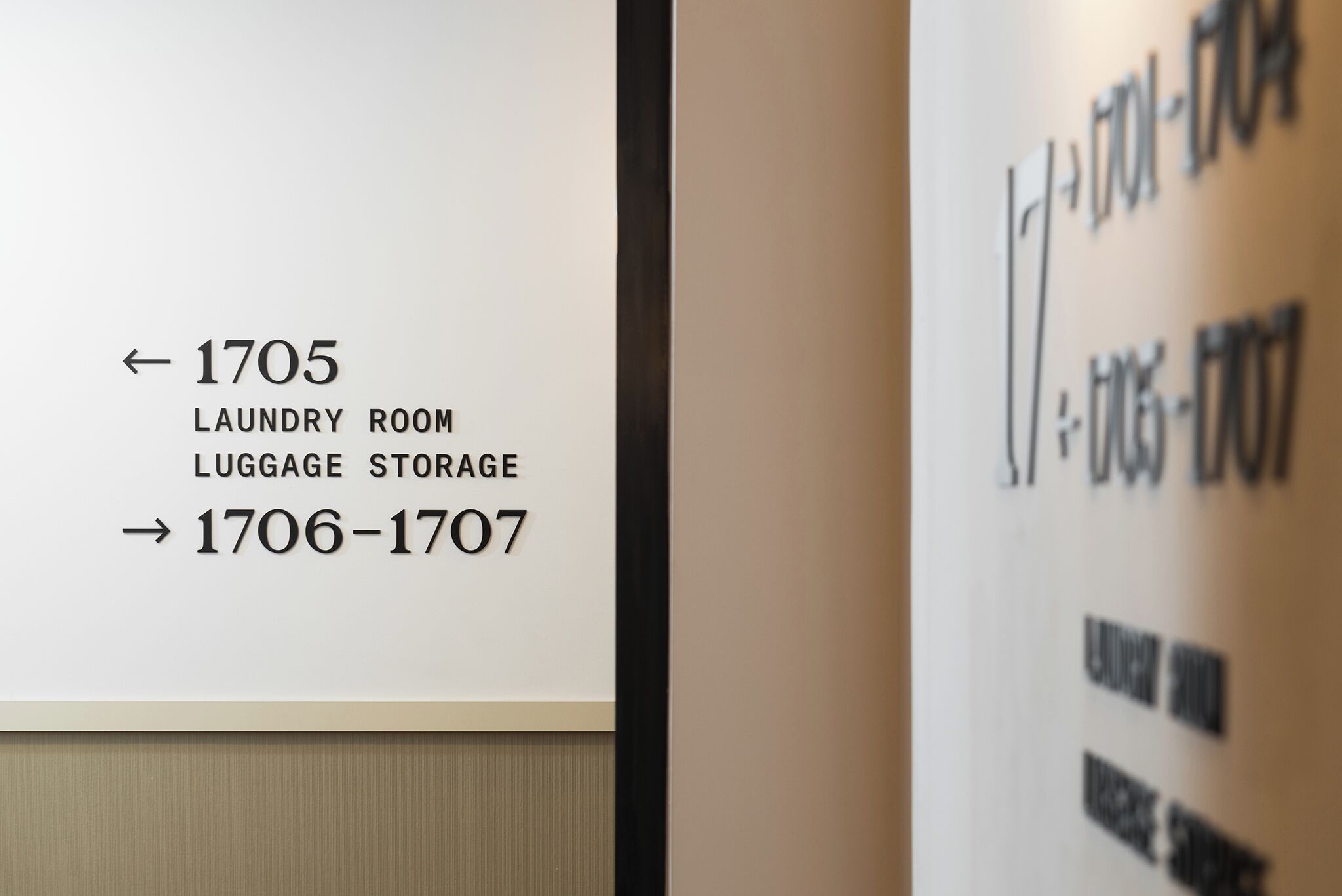 A directional sign indicating the location of the laundry room and luggage storage, with arrows pointing to 1705 and 1706-1707.