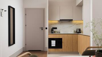 A modern kitchen with wooden cabinets, a black oven, and a marble countertop.
