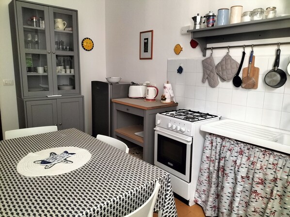 Fridge, stovetop, cookware/dishes/utensils, dining tables