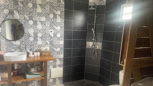 A bathroom with a sink, mirror, shower, and toilet. - Country house 20 min from the beach (Rivière-Pilote)