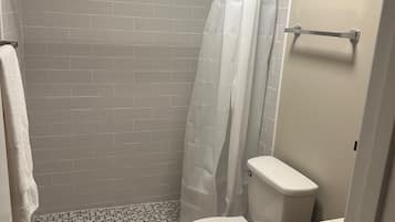 Shower, towels, soap, toilet paper