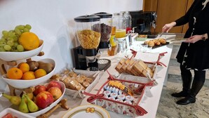 A buffet setup with various food items and beverages.