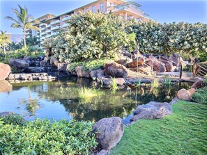 A landscaped garden with a pond, rocks, and greenery. - Honua Kai | Ocean View 5 BR, Sleeps 16 | Car Incl. w/ 6+ Nights | HKH ML-1784 by KBM (Lahaina)