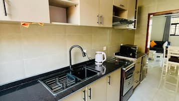 Apartment, Balcony, City View | Private kitchen | Fridge, microwave, stovetop, electric kettle