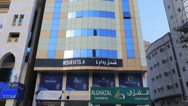 A tall hotel with a modern design, featuring a prominent sign for 'WEDAH HOTEL 4'. - Golden Aziziyah (Makkah)