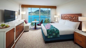A hotel room with a bed, a TV, a small table with a plant, a chair, and a view of the ocean. - Beautiful Ocean View Studio at Marriott Kauai Beach Club (Knoxville)