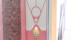 A pink and white door with a decorative panel and a geometric design. - Furnished apartment in Minya with archaeological tours (Minya Governorate)