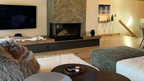 A cozy living room with a fireplace, wooden beams, a flat-screen TV, and modern furniture. - T4 spacieux avec cheminée (Peisey-Nancroix)