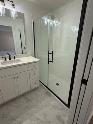 Shower, hair dryer, towels, toilet paper