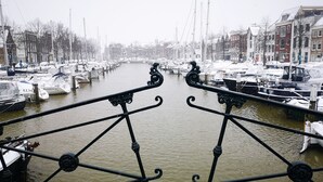 A canal with boats docked on both sides, surrounded by buildings. - Historic townhouse with 5 bedrooms In Holland's oldest city center, airco (Dordrecht)