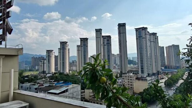 A cityscape with high-rise buildings and a clear sky.
