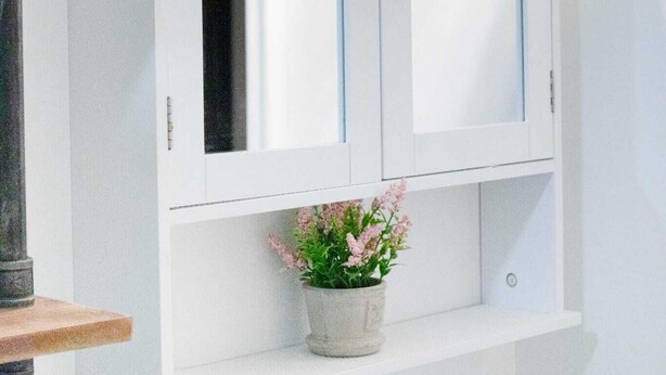 A white cabinet with two doors and a small shelf below. - Ideal for long stays, Near/airport GYM-Parking. (Toronto)