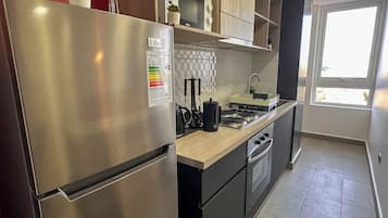Family Apartment, 2 Bedrooms, Lagoon View | Private kitchen | Full-size fridge, microwave, stovetop, cookware/dishes/utensils