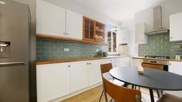 Fridge, oven, toaster, dining tables