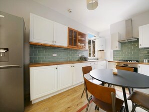 Fridge, oven, toaster, dining tables