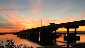 A bridge over calm water during sunset with a clear sky. - Cottage & Bungalow | Coastal 2-Unit Retreat (St. Augustine)