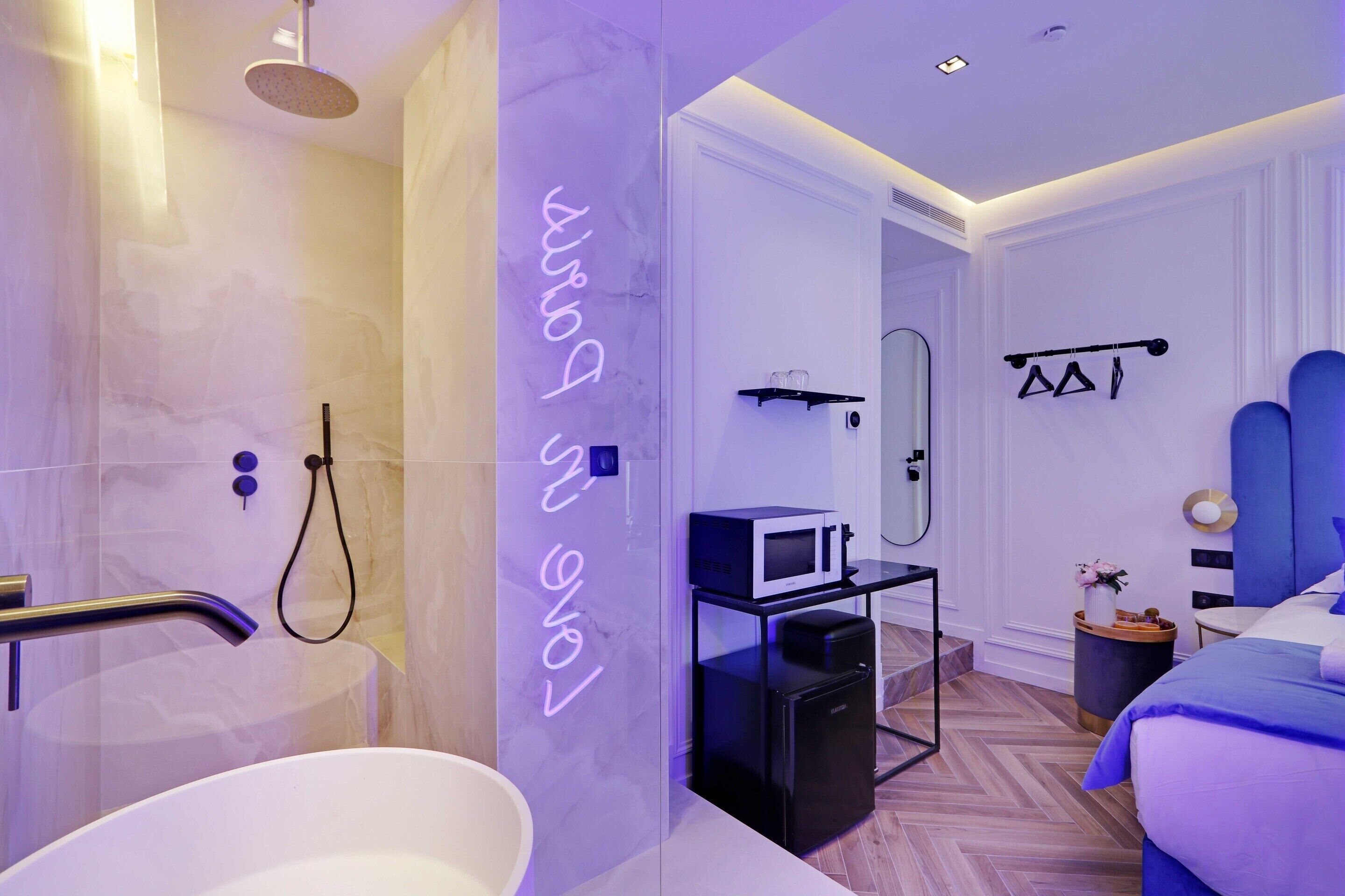 A modern bathroom with a shower, a sink, and a vanity with a mirror.