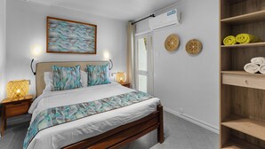 A modern bedroom with a wooden bed, a bedside table with a lamp, a wall-mounted air conditioner, and decorative wall art.