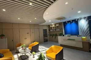 A modern reception area with a curved ceiling, seating arrangements, and a reception desk.