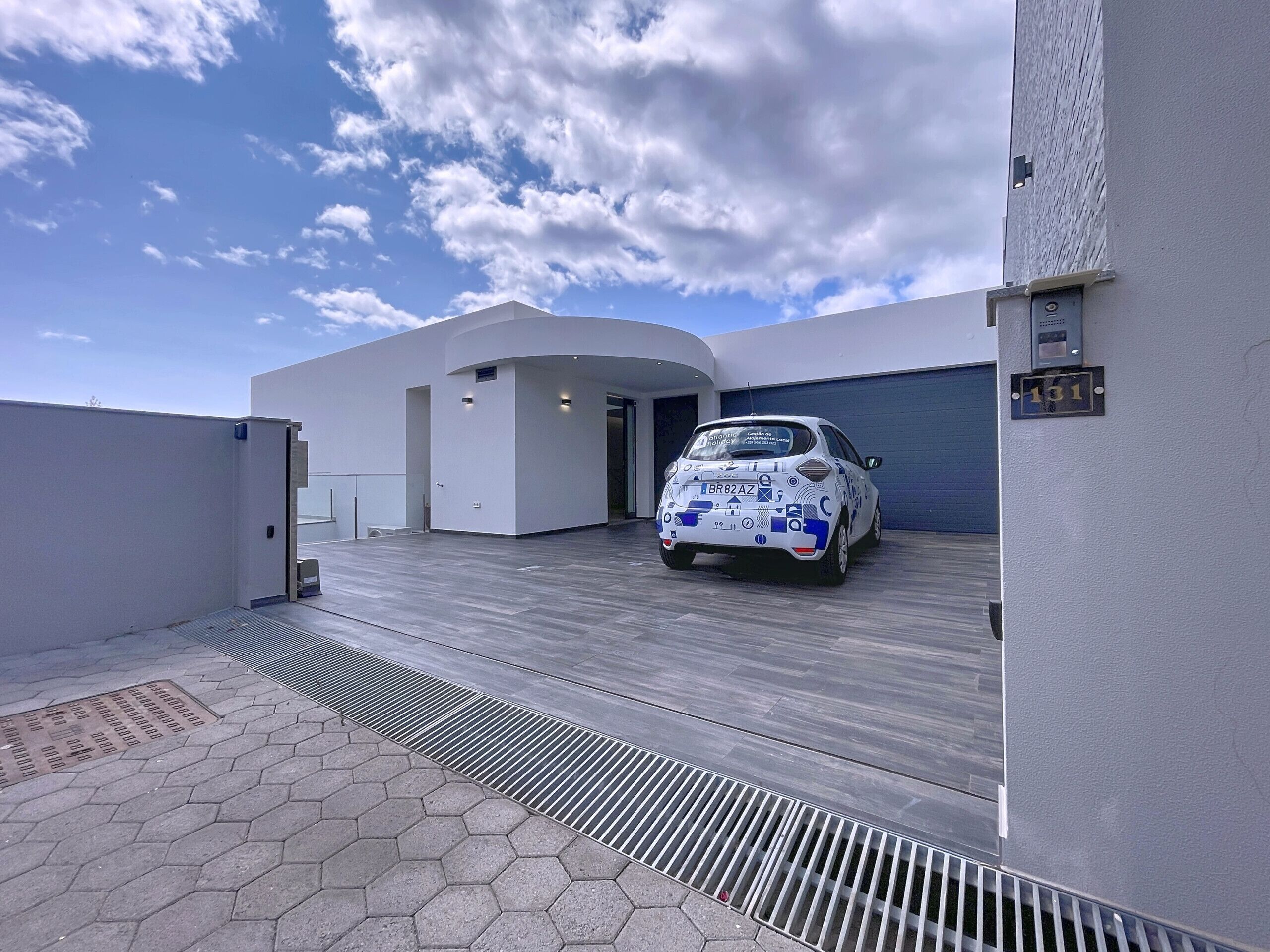 A modern building with a car parked in front.